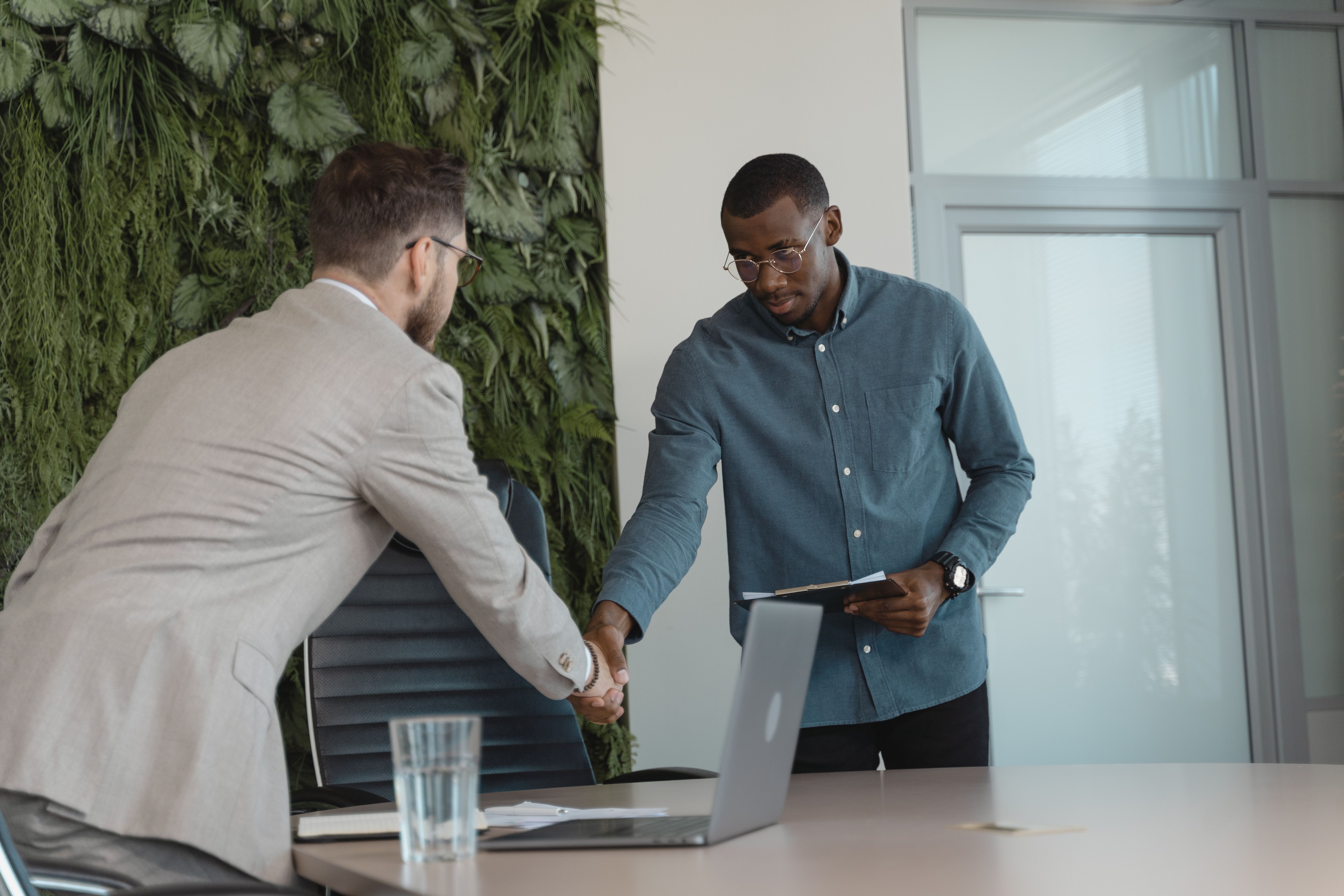 Business partners shaking hands after a meeting, symbolizing trust built through transparent business practices.