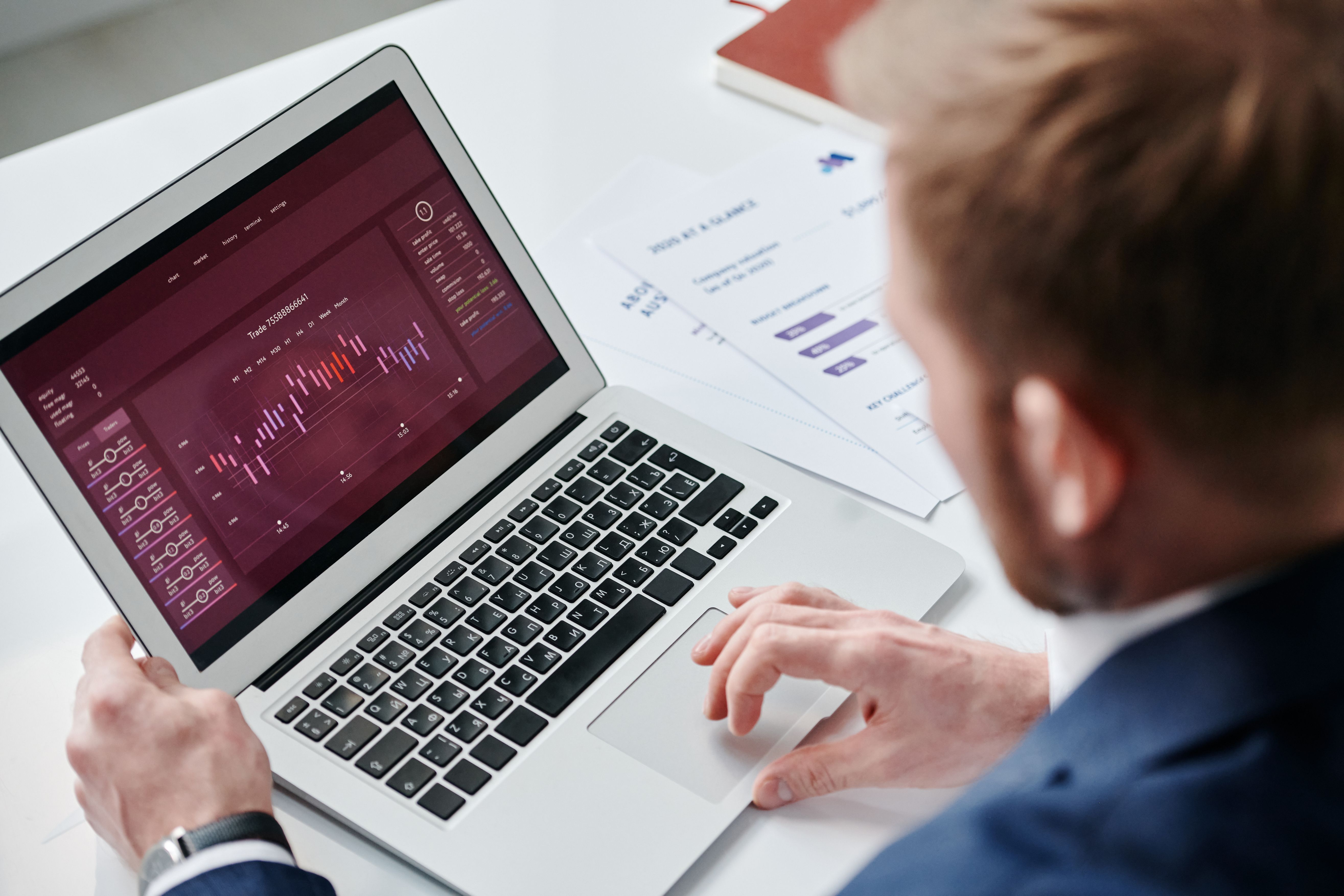 Professional reviewing an analytics dashboard on a laptop, suggesting accessible and understandable business data.