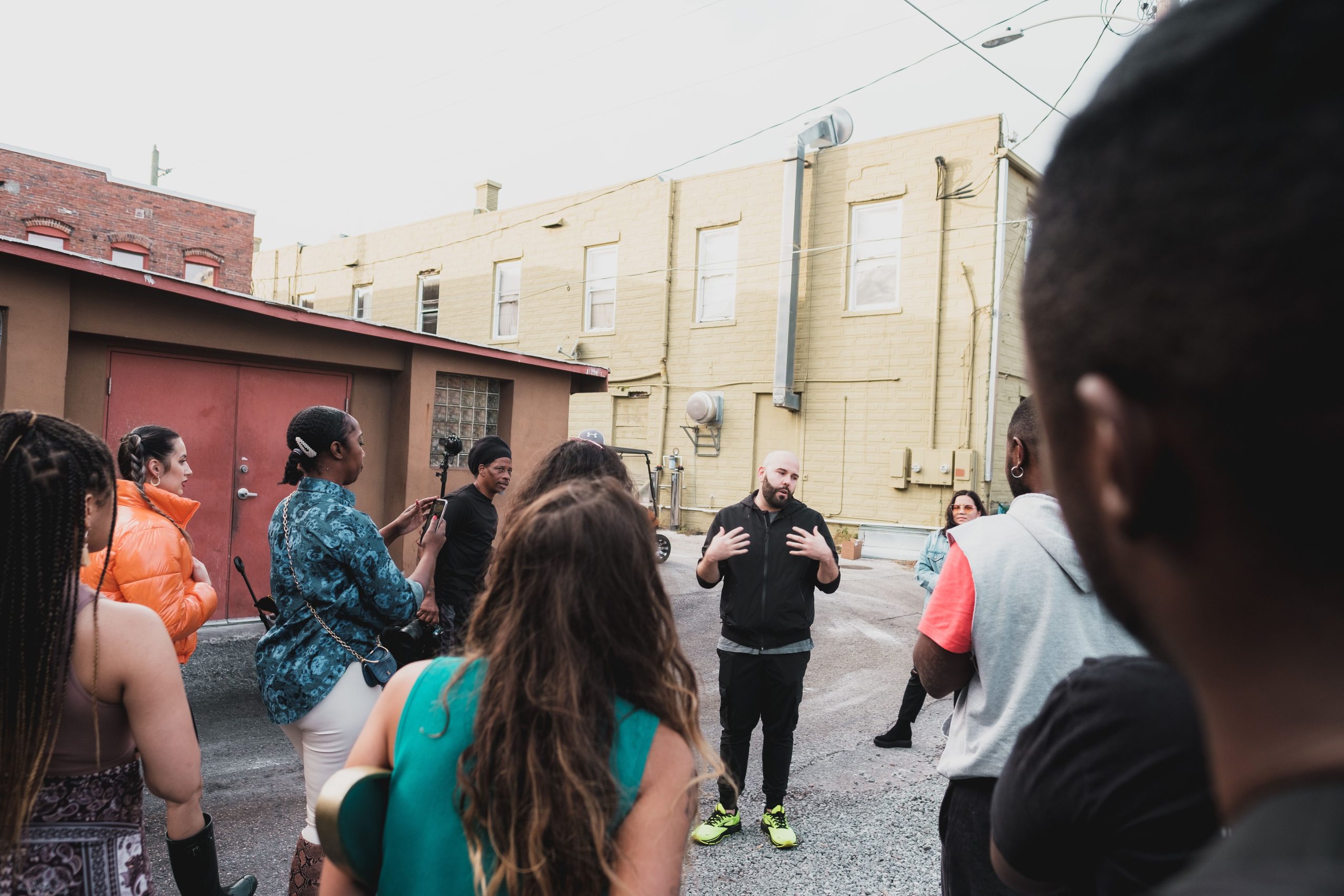 Diverse adults taking part in a community meeting on an urban street