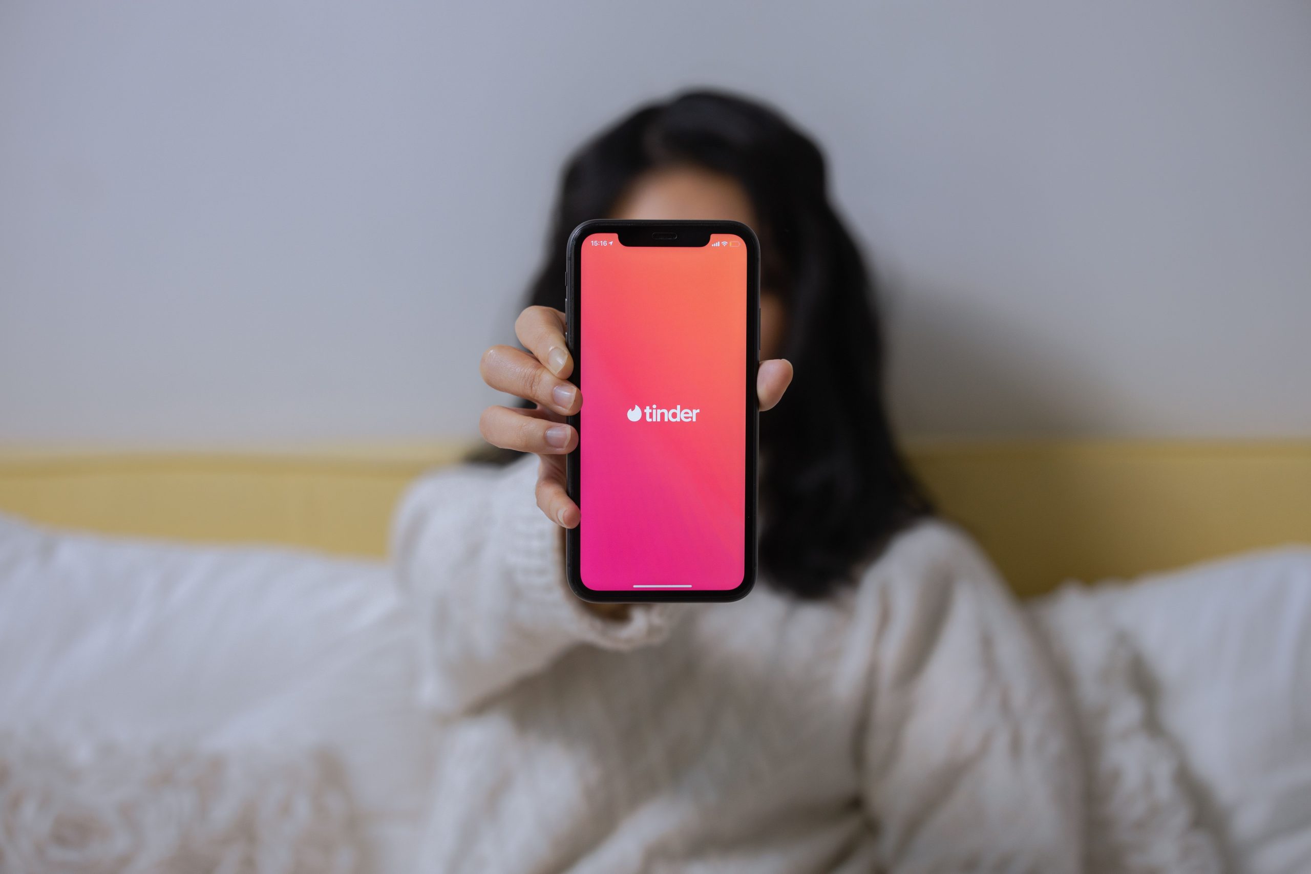 Woman browsing a dating app on her smartphone, representing greater agency in modern dating.