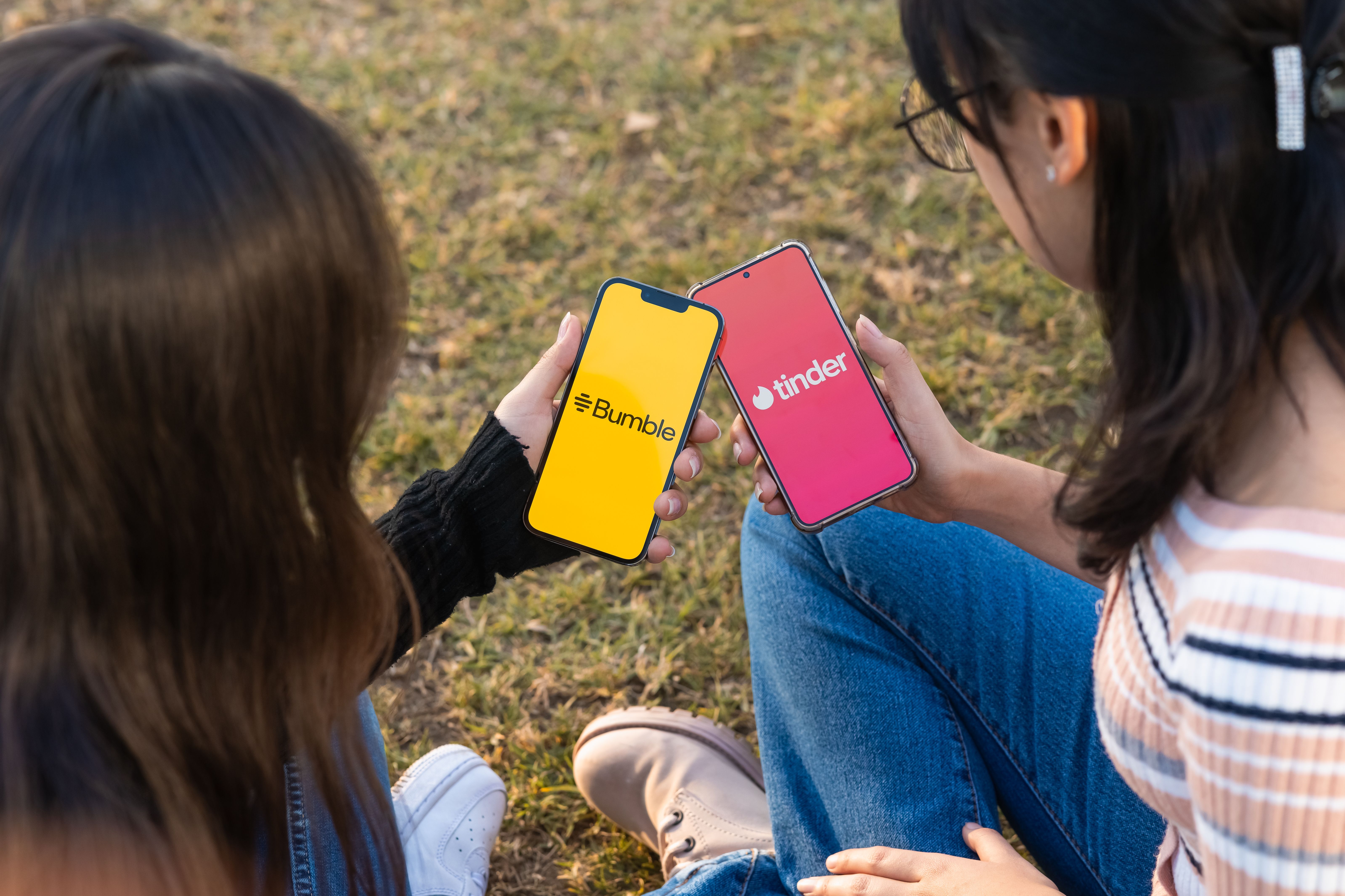 Two women using dating apps together, showing how friends can support intentional online dating.
